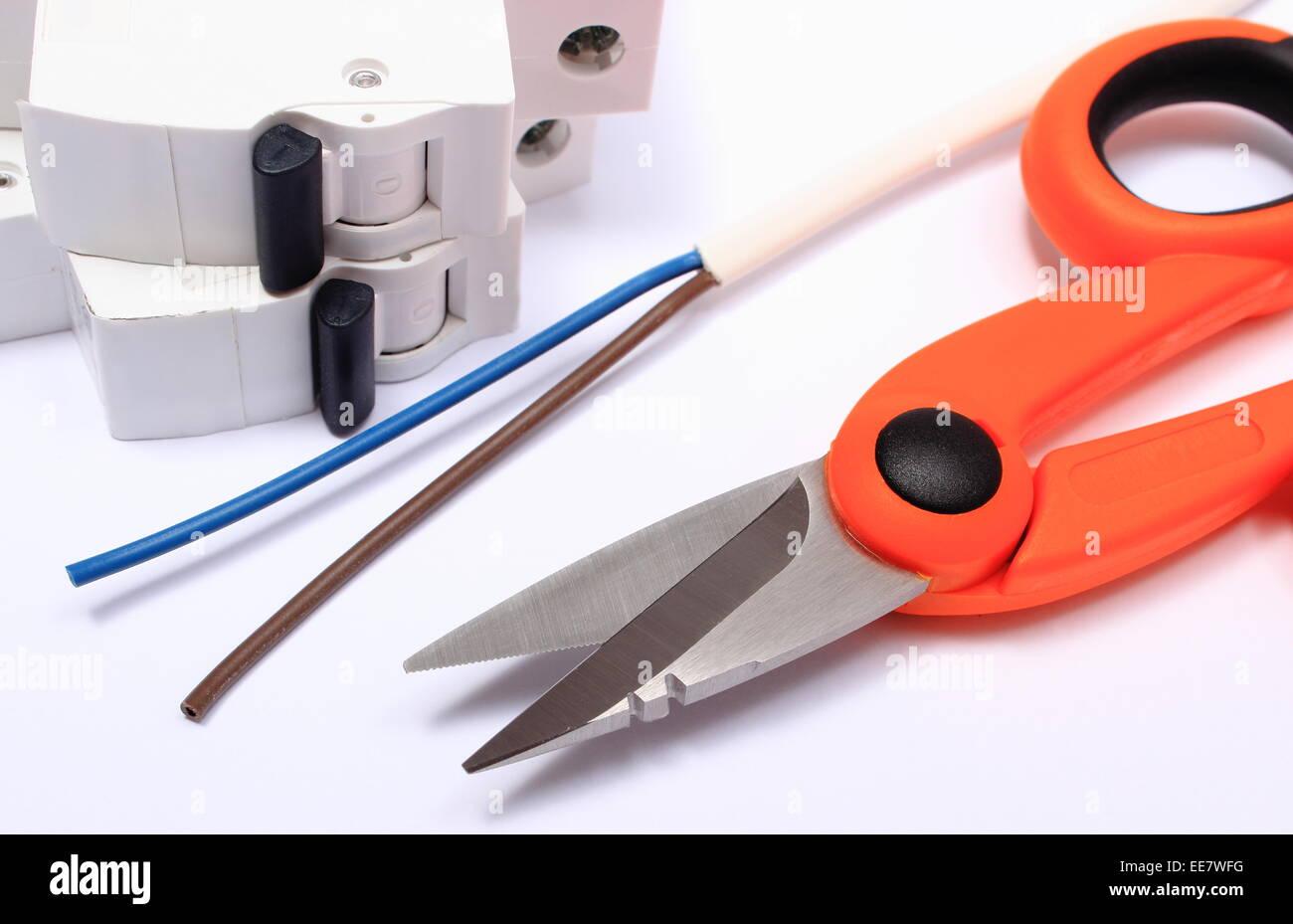 Cable cutter, electric wire and fuse lying on white background