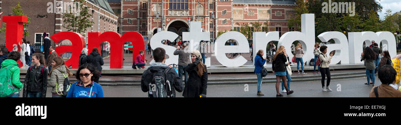 Tourists in Amsterdam,Holland gather to have their picture taken at the iconic Iamsterdam sign Stock Photo
