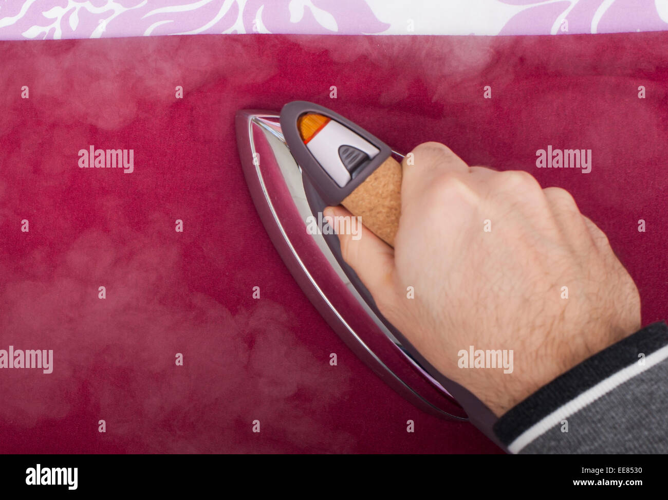 Close up of a man's hand while ironing. Stock Photo
