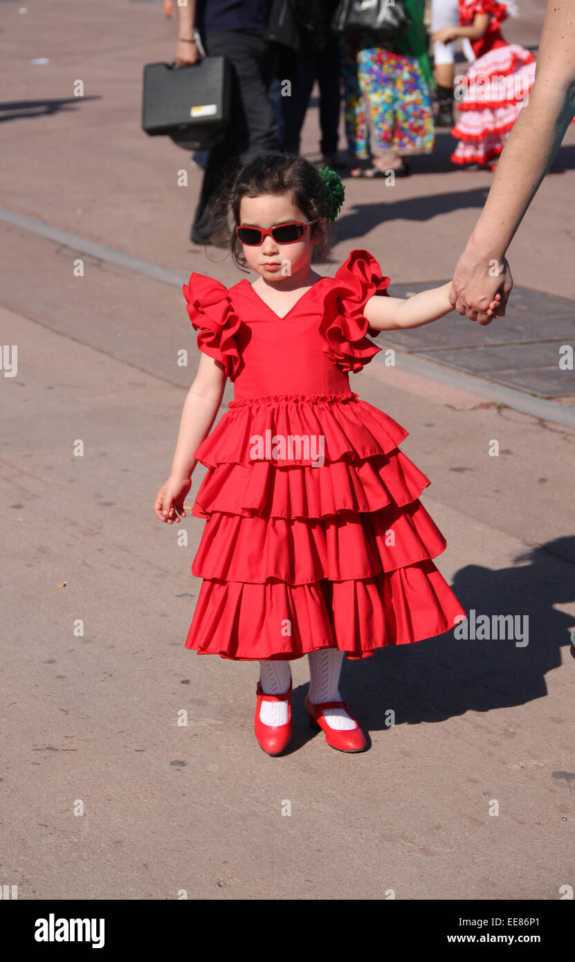 Young girl in traditional red Spanish flamenco dress at the Feria de Abril  de Catalonia (April Fair of Catalonia) in Barcelona Stock Photo - Alamy