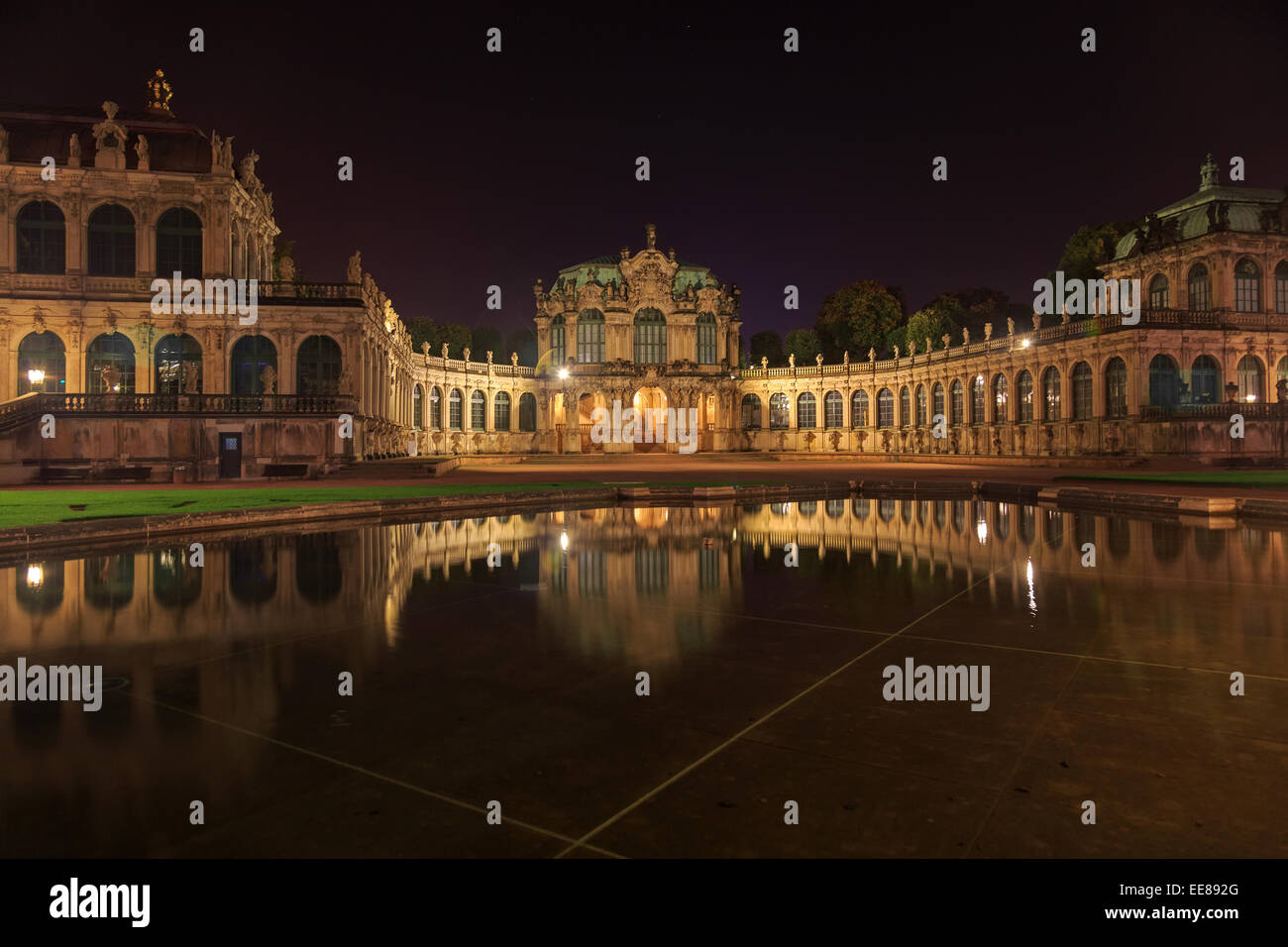 Dresden Zwinger palace panorama with illumination at night and water reflection, Germany Stock Photo