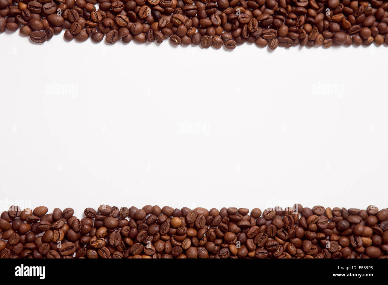 Brown roasted coffee beans on white background Stock Photo - Alamy