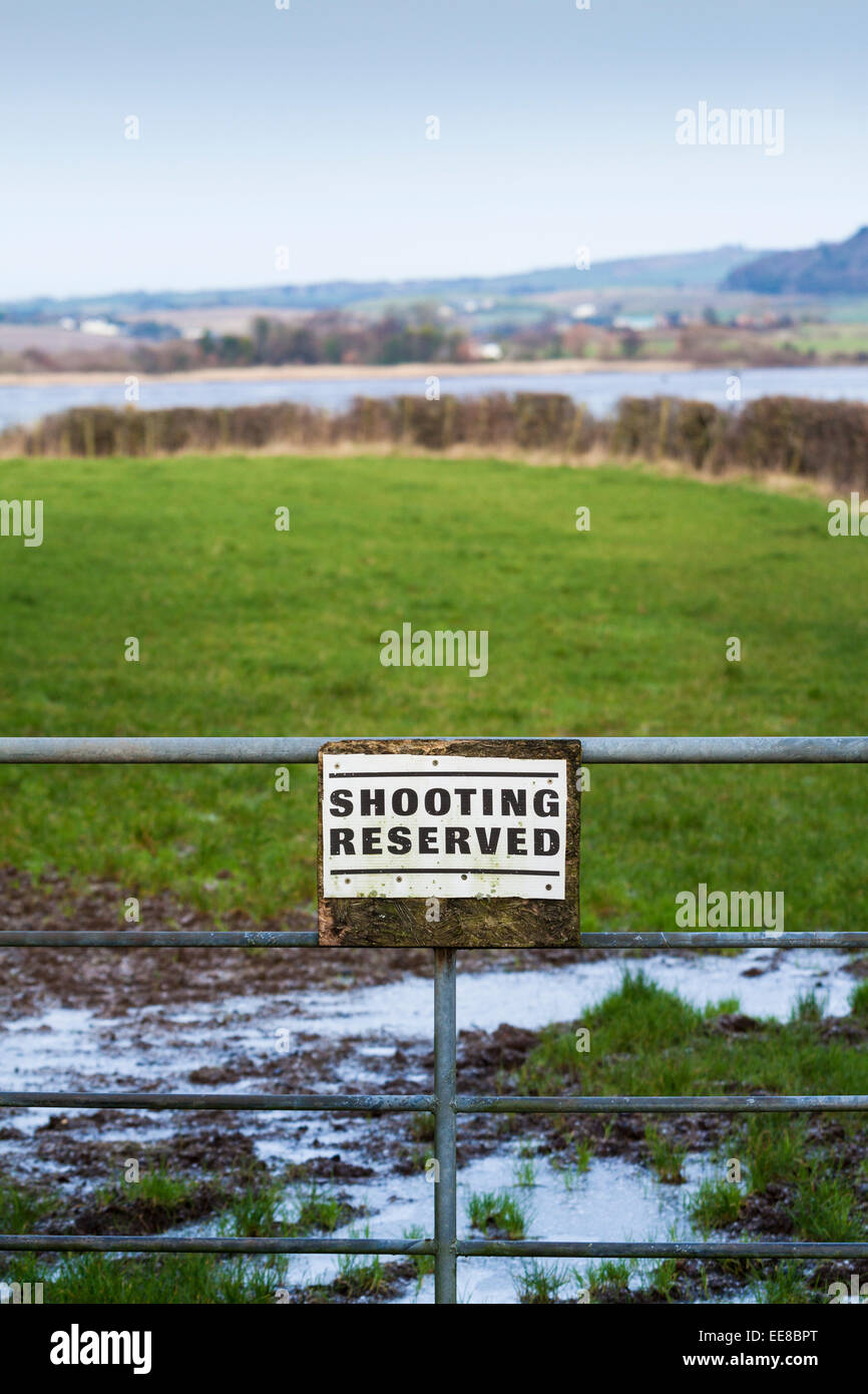 Shooting reserved sign on gate into a field Stock Photo