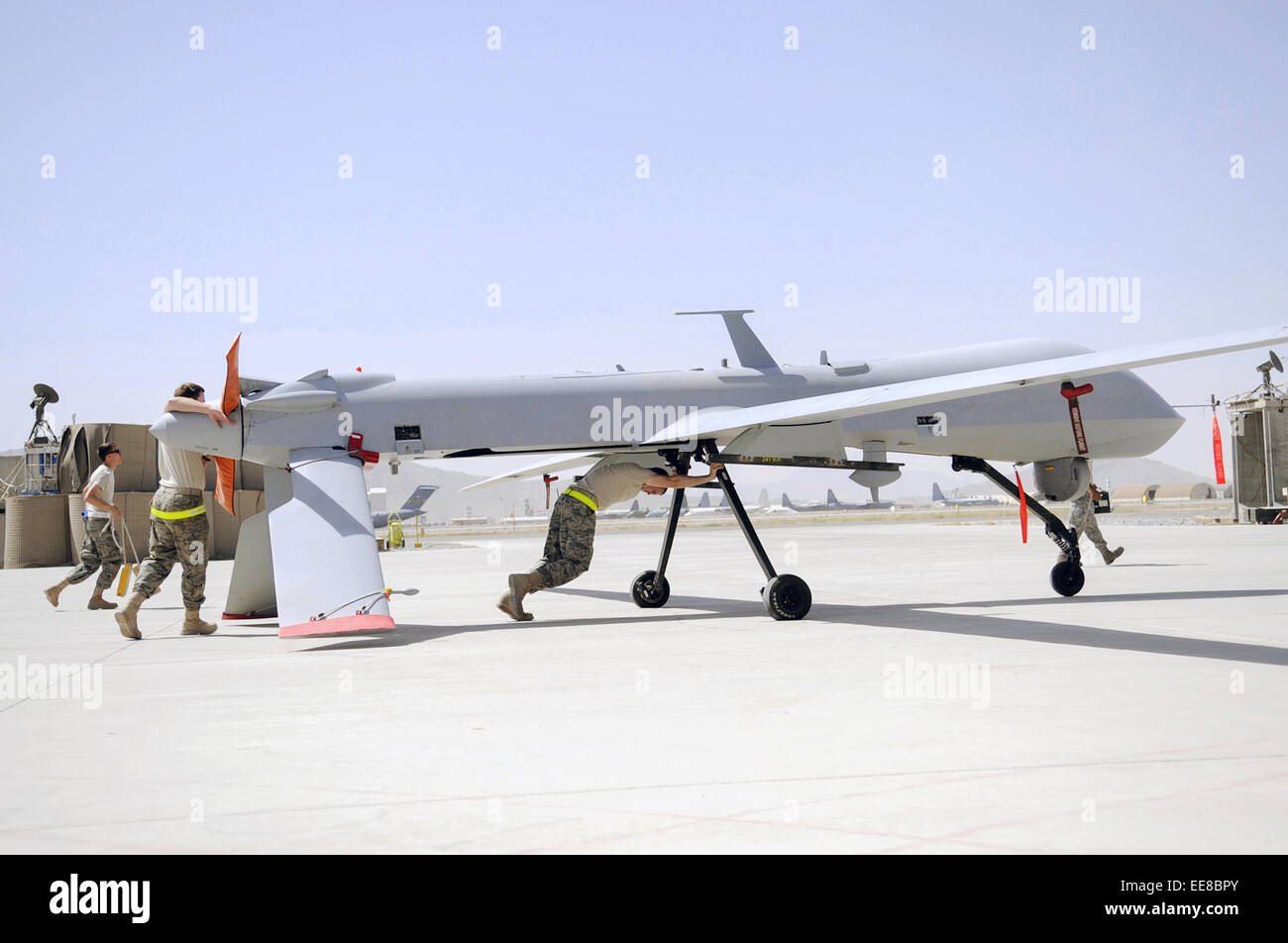 MQ-1 Predator drone being pushed to a hangar for routine maintenance by members of the 451st Expeditionary Aircraft Maintenance Squadron Stock Photo