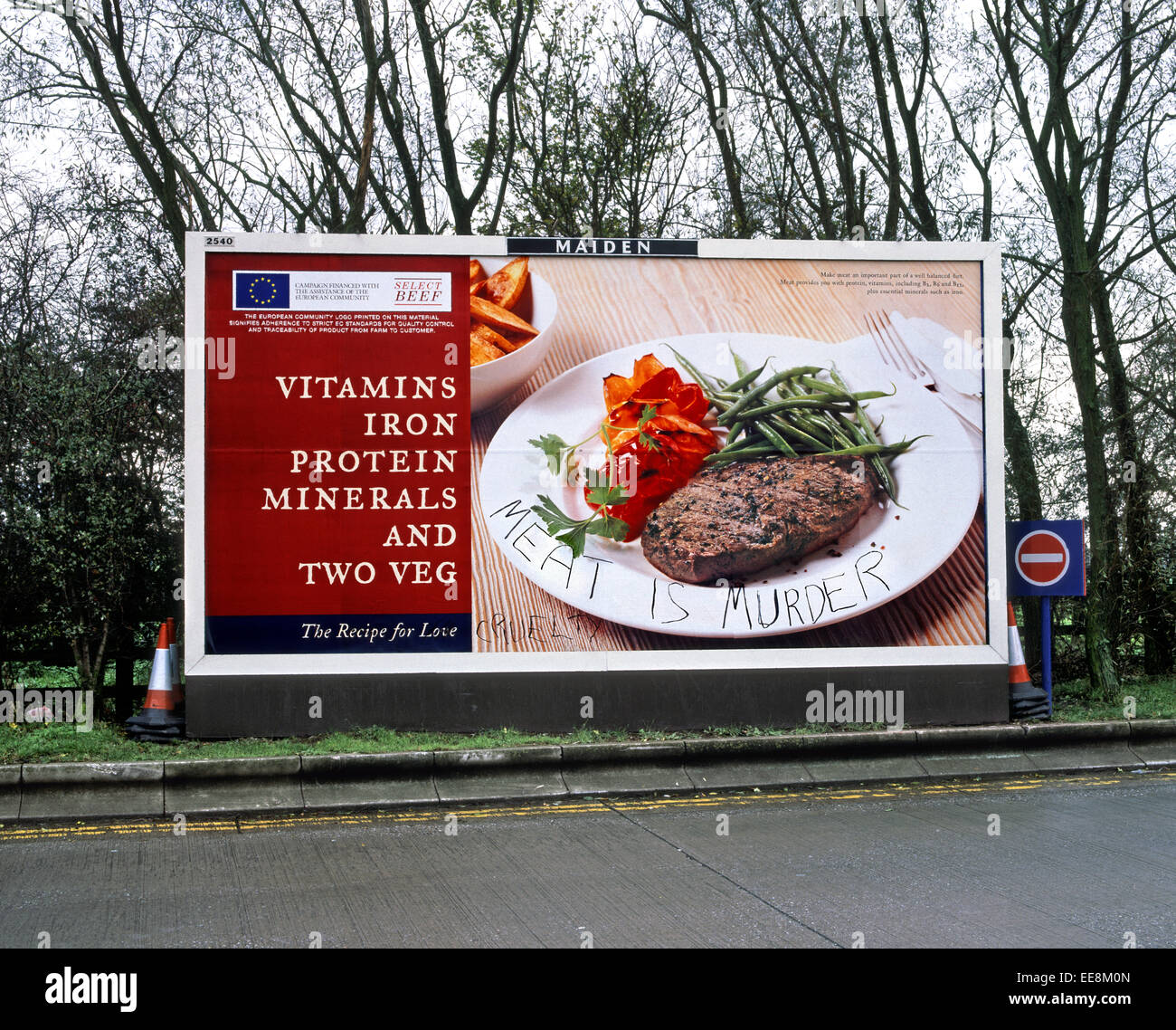 'Meat is Murder' - vegetarian/animal rights slogan written on a  poster advertising beef. Stock Photo