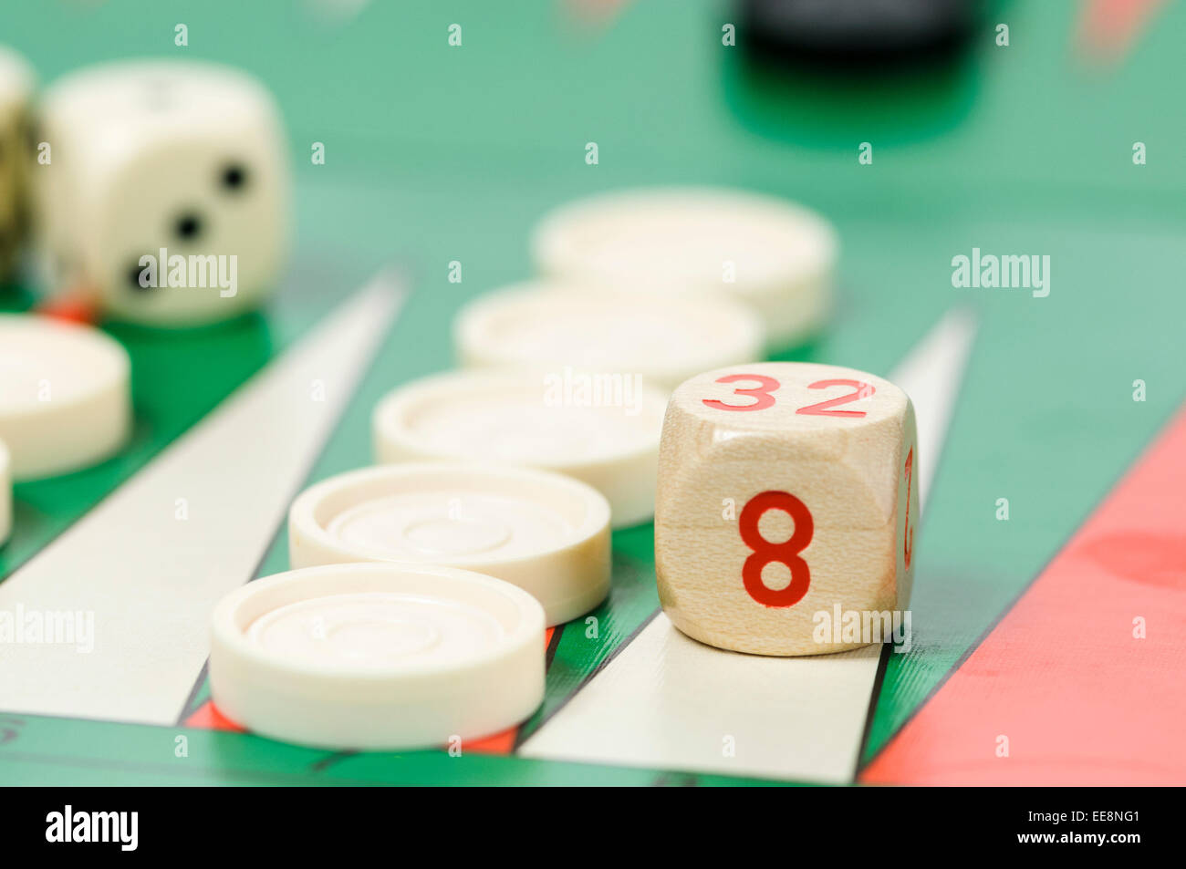 Pieces and a dice on a Backgammon board game Stock Photo