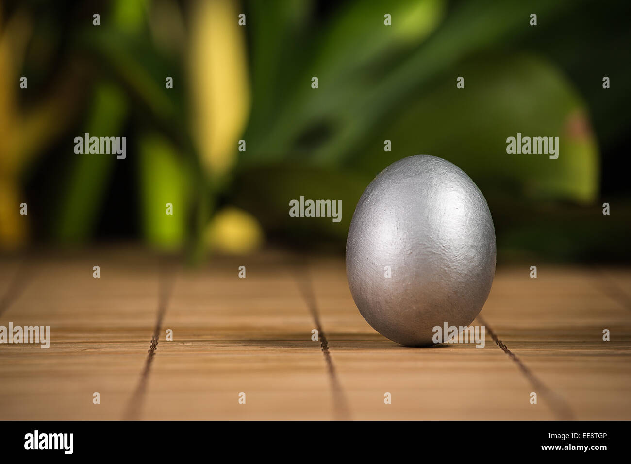Silver Easter eggs with wood background Stock Photo - Alamy