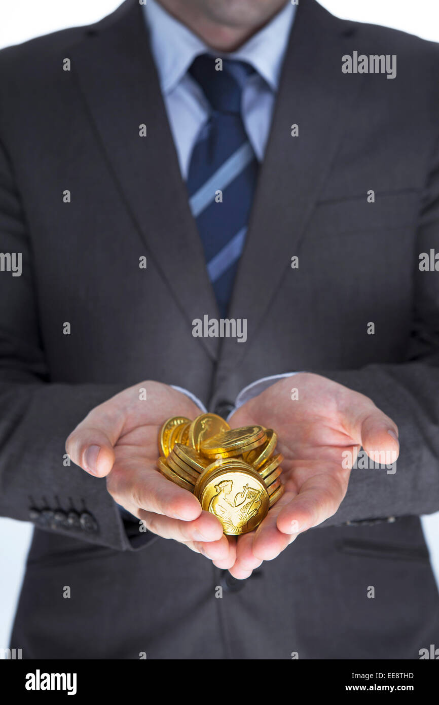 Business man holding golds in hands. Finance concept Stock Photo