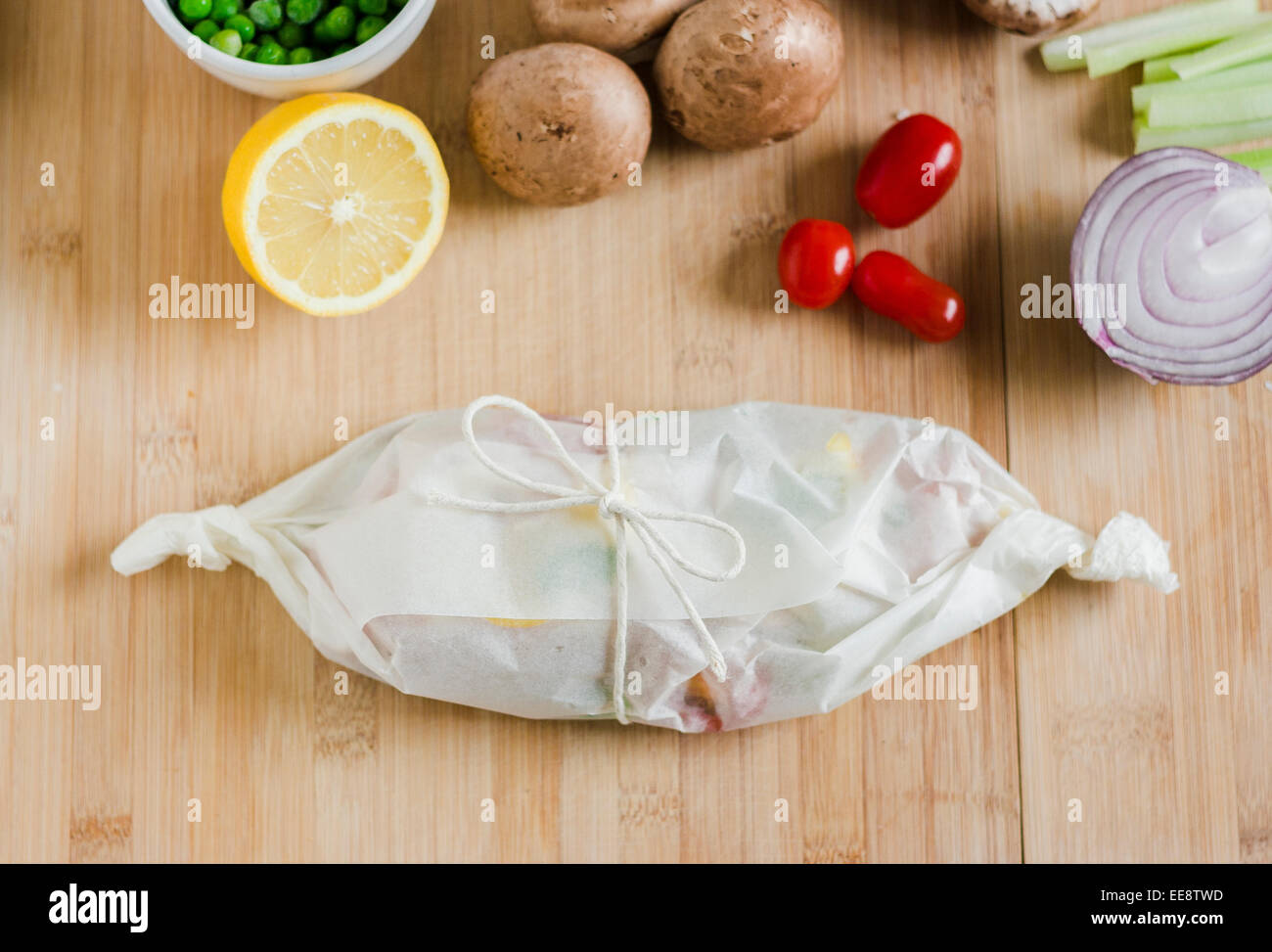 One parcel tied with string in a bow surrounding by different ...