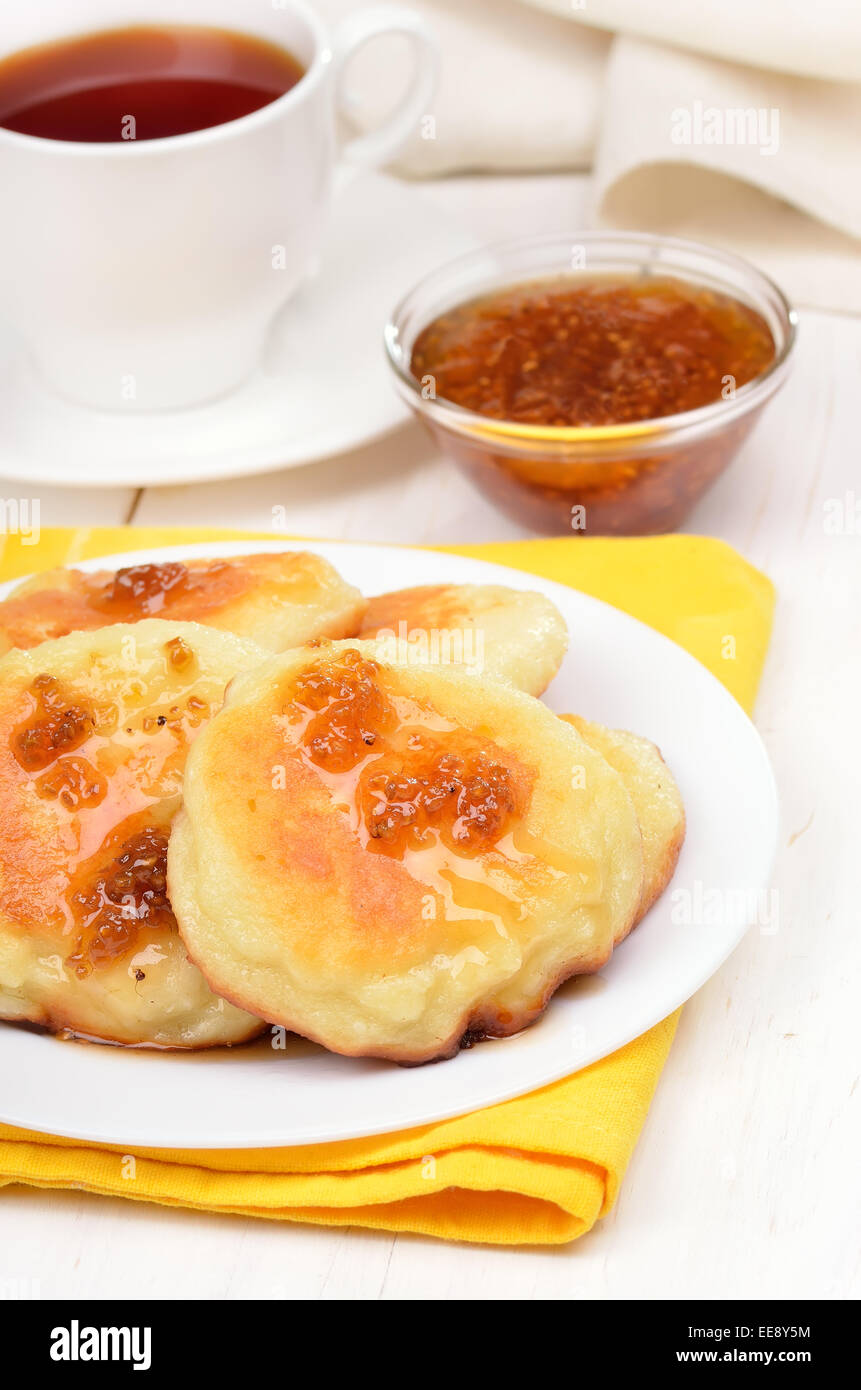 Fritters with yellow raspberry confiture on white wooden table Stock ...