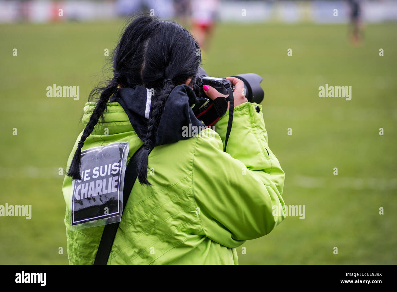 A photographer with ' je suis charlie ' on the back. This image was taken during an official  rugby match. Stock Photo