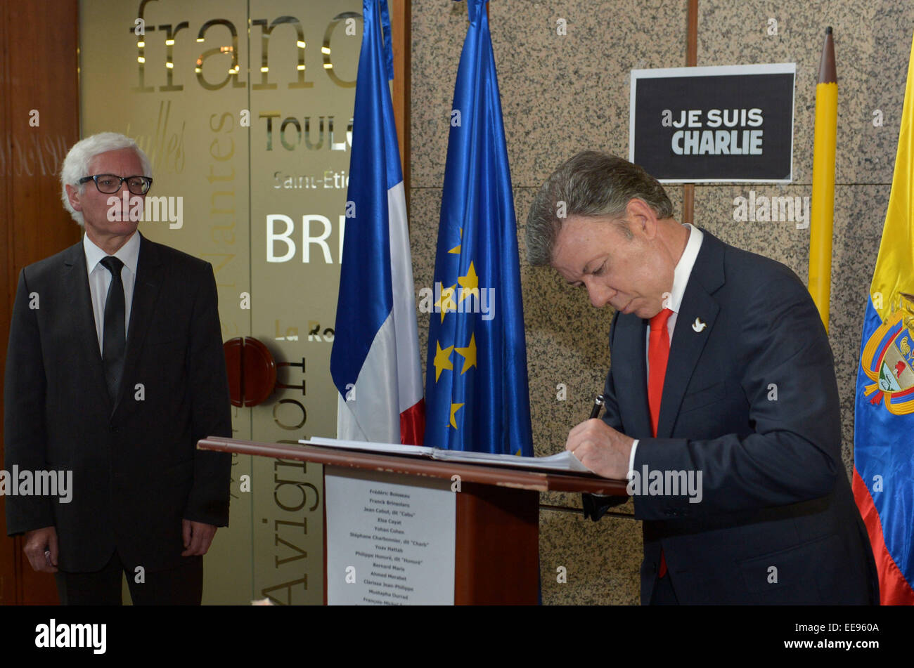 Bogota, Colombia. 14th Jan, 2015. Image provided by Colombia's Presidency shows Colombian President Juan Manuel Santos (R) signing the Book of Condolences for the victims of the attack to the French weekly 'Charlie Hebdo', next to French ambassador to Colombia Jean-Marc Laforet (L), at the French Embassy in Bogota, capital of Colombia, on Jan. 14, 2015. © Juan Pablo Bello/Colombia's Presidency/Xinhua/Alamy Live News Stock Photo