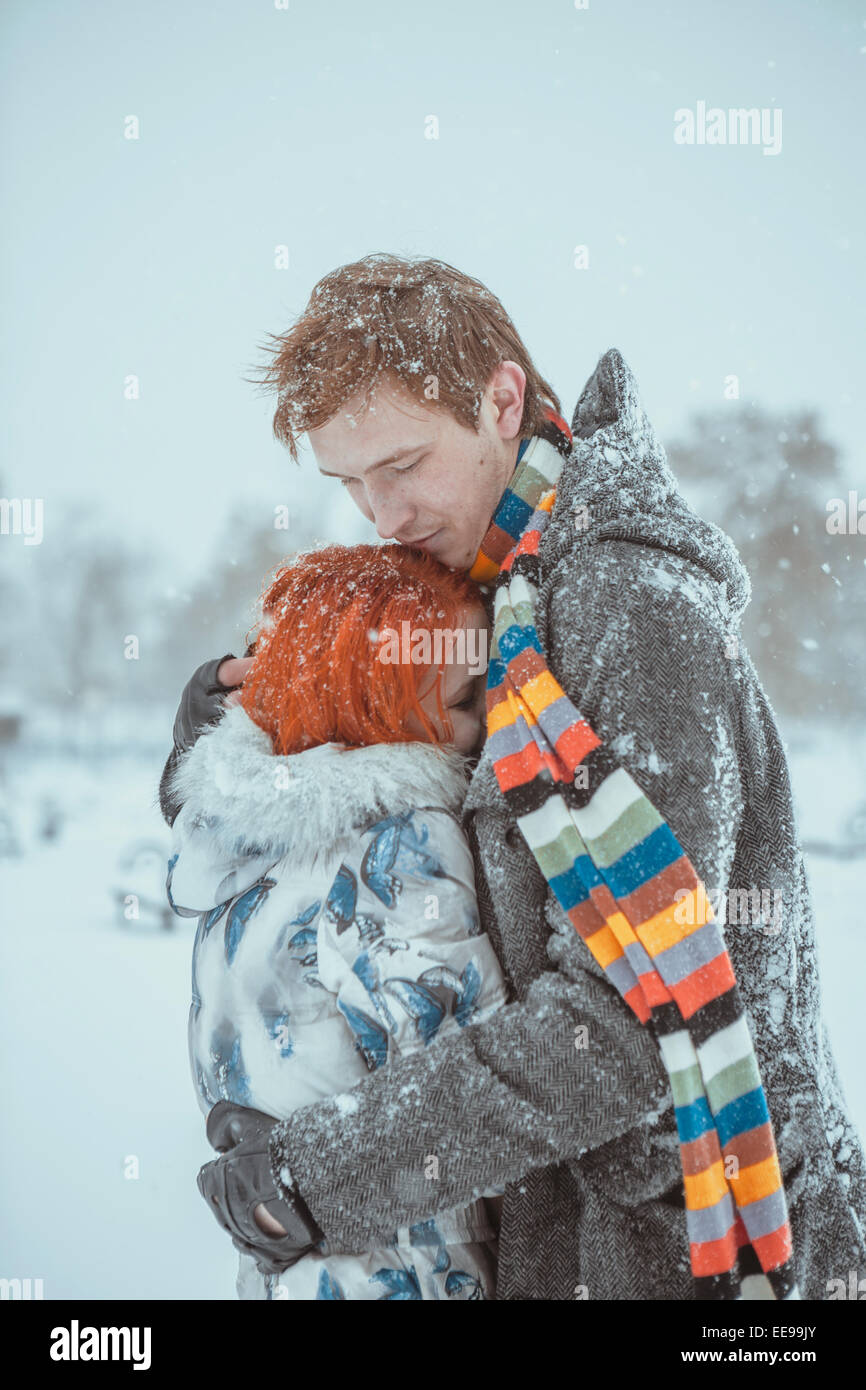 Happy Young Couple in Winter Park Stock Photo - Alamy