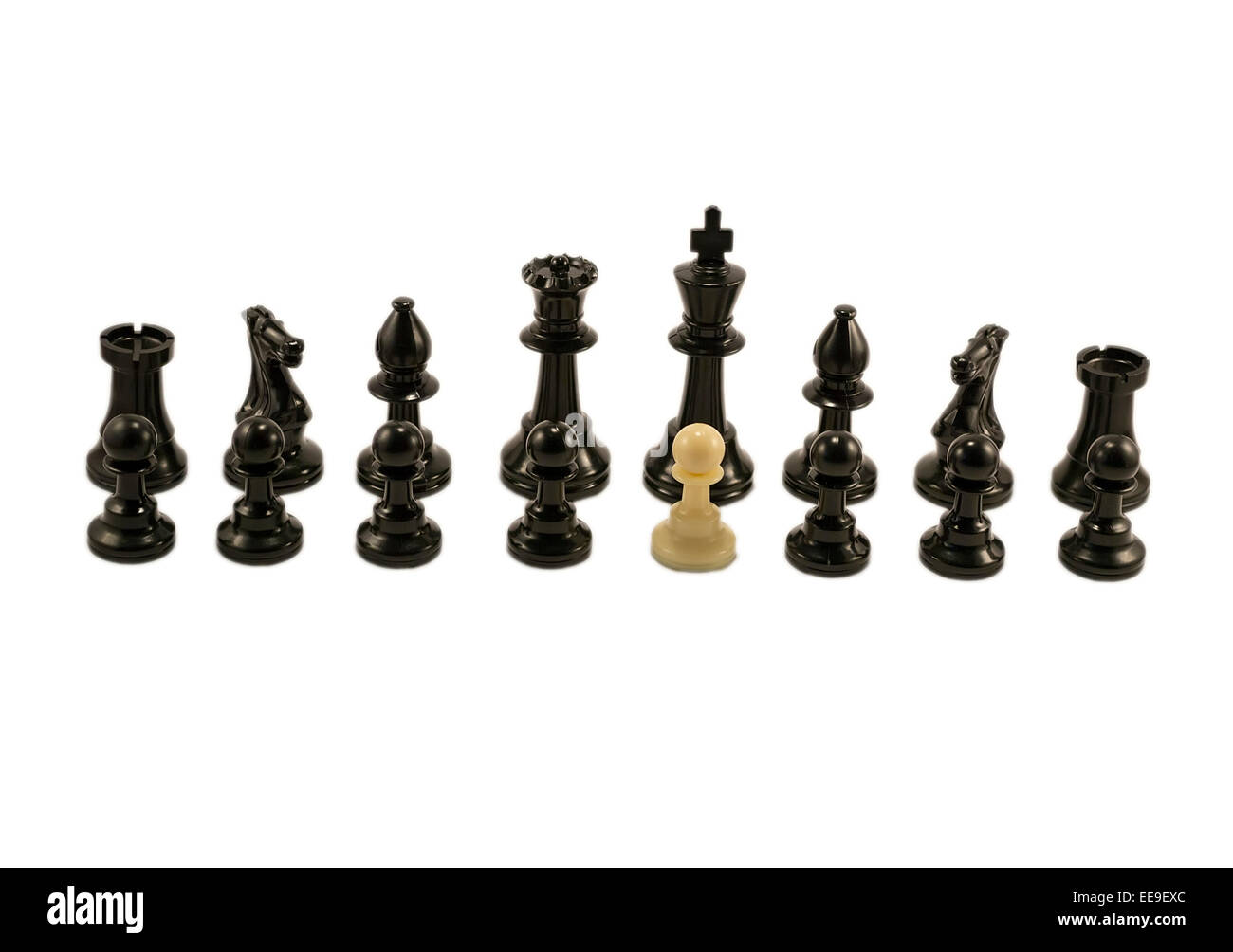 White pawn standing alongside the chess black pieces Stock Photo