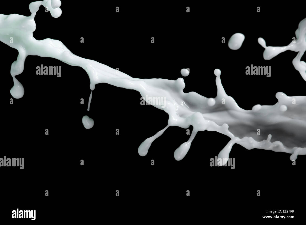 milk or white liquid splash on black background Stock Photo - Alamy