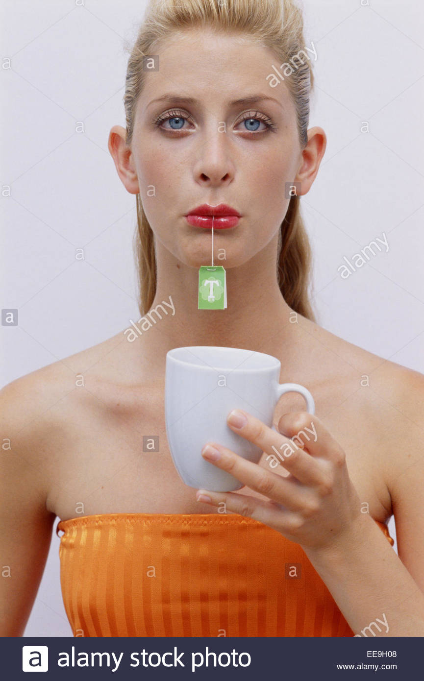 young-woman-with-tea-bag-in-her-mouth-EE9H08.jpg