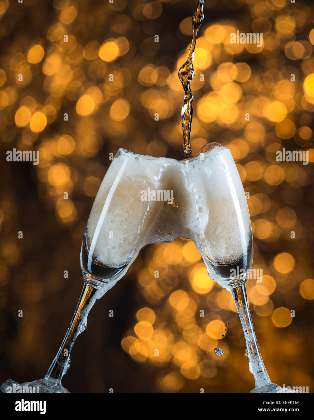 Two champagne glasses splash with drops hi-res stock photography and ...