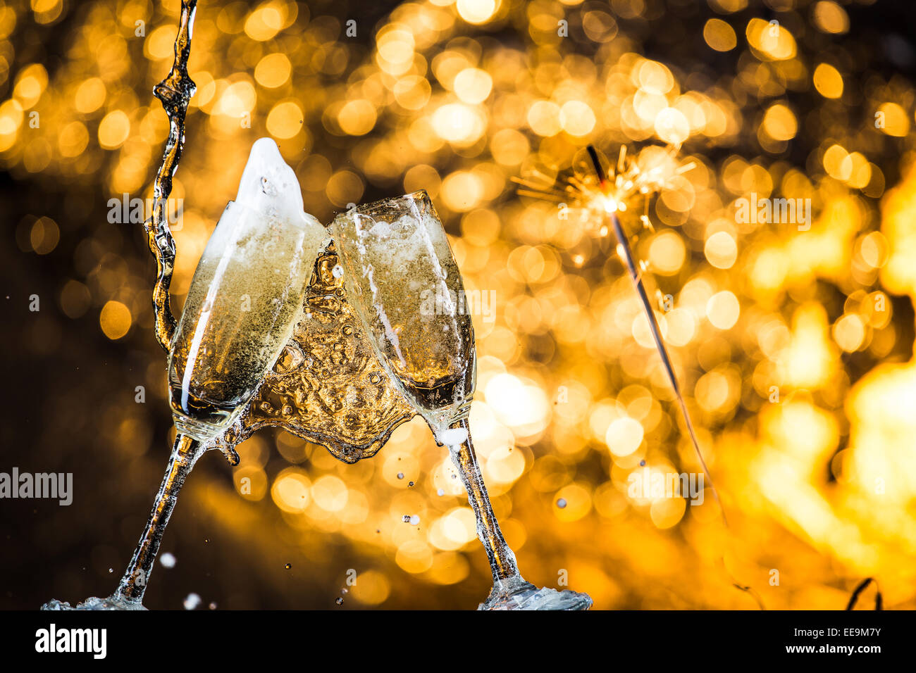 Two champagne glasses splash with drops hi-res stock photography and ...