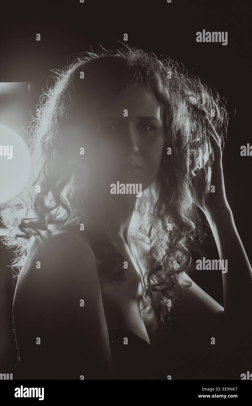 A black and white image of a beautiful young woman with flowing hair ...