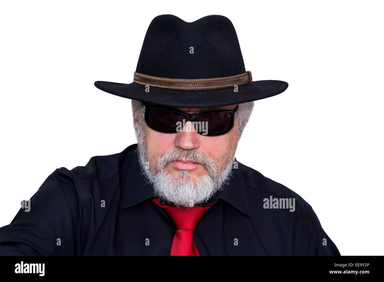 Gray haired senior with hat, sunglasses and red necktie looking into camera Stock Photo