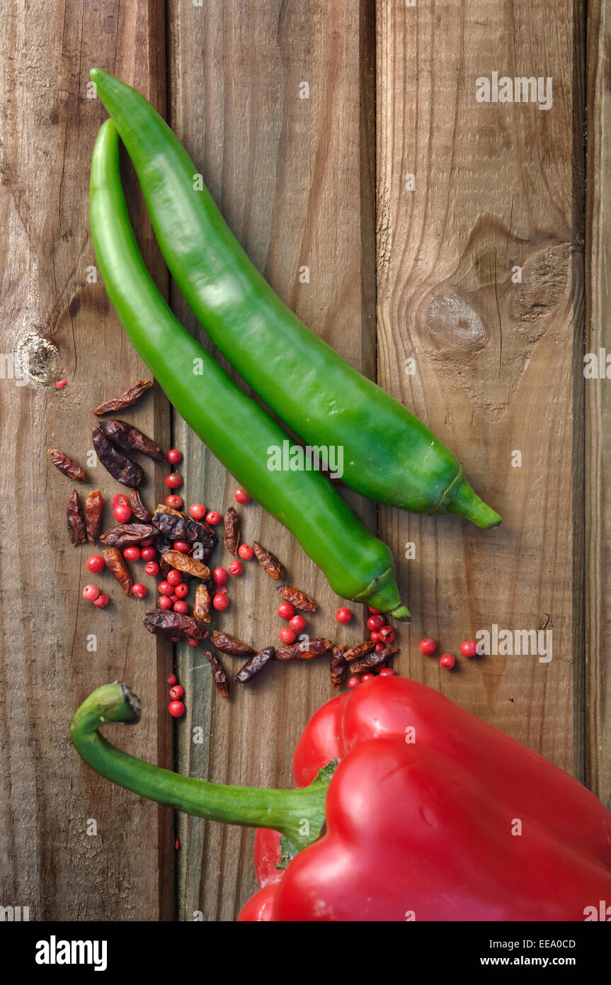 peppers, cayenne peppers and pepper on wooden table Stock Photo