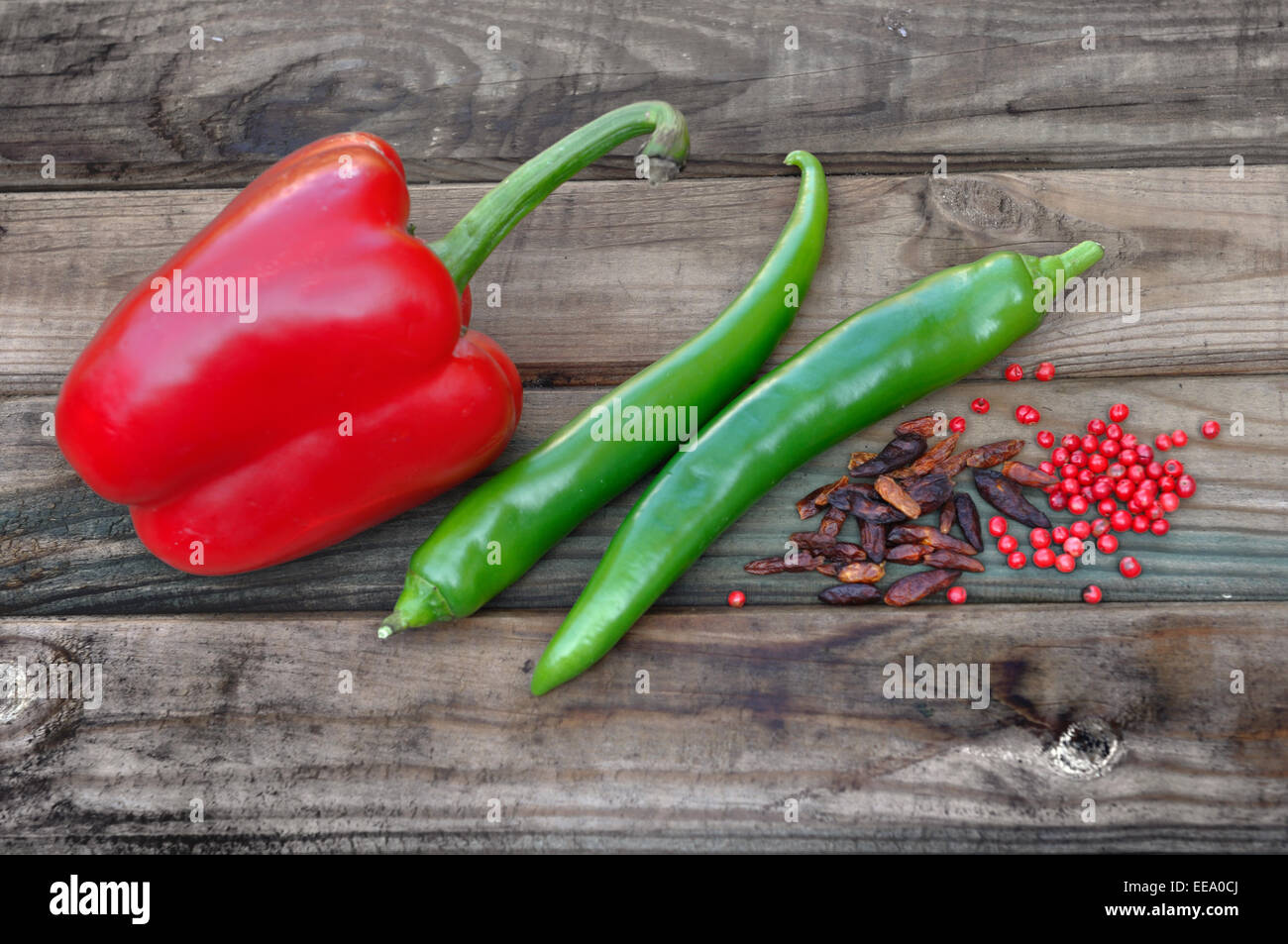 peppers, cayenne peppers and pepper on wooden table Stock Photo
