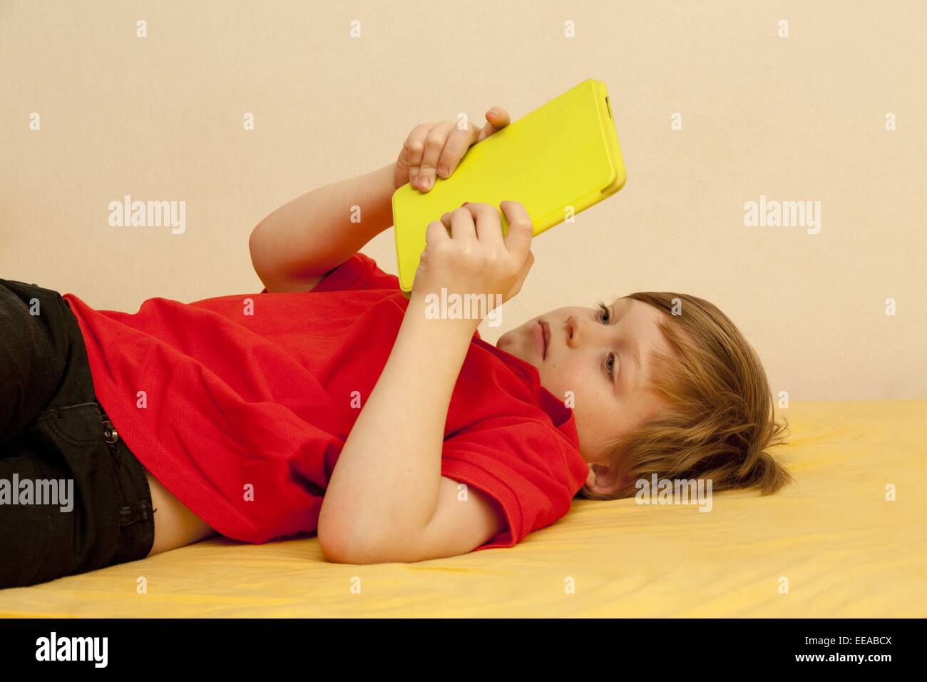young boy playing with his tablet PC Stock Photo