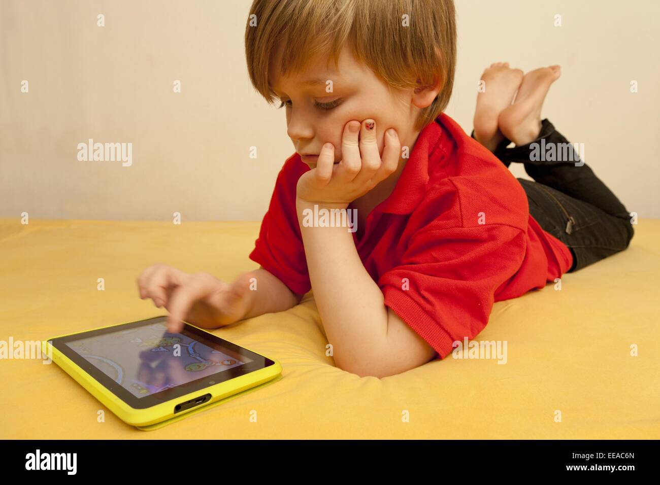 young boy playing with his tablet PC Stock Photo