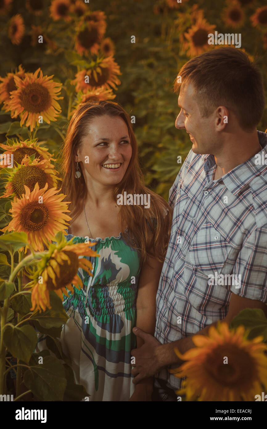 Beautiful couple having fun in sunflowers fields Stock Photo - Alamy
