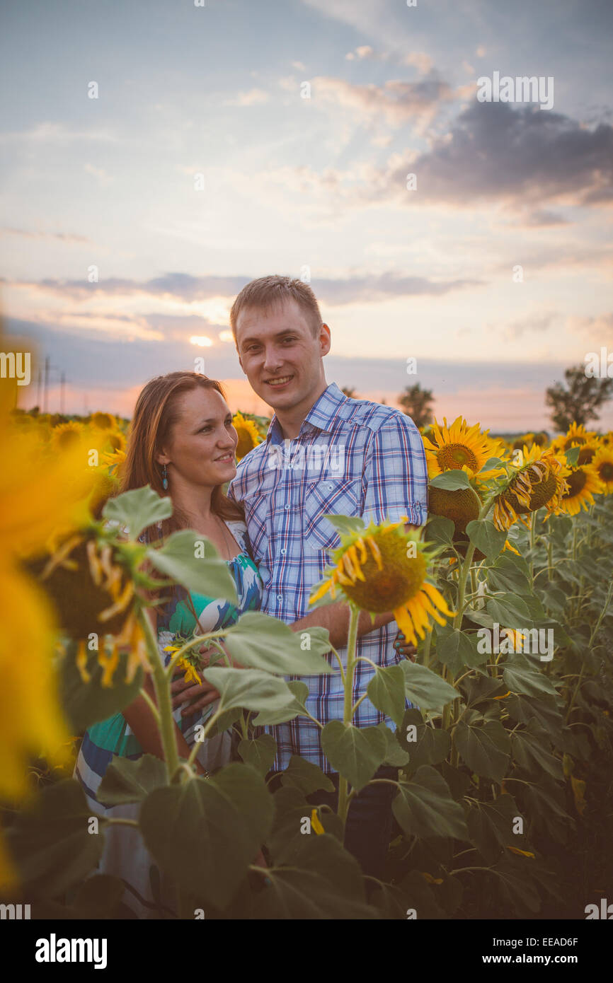 Beautiful couple having fun in sunflowers fields Stock Photo - Alamy