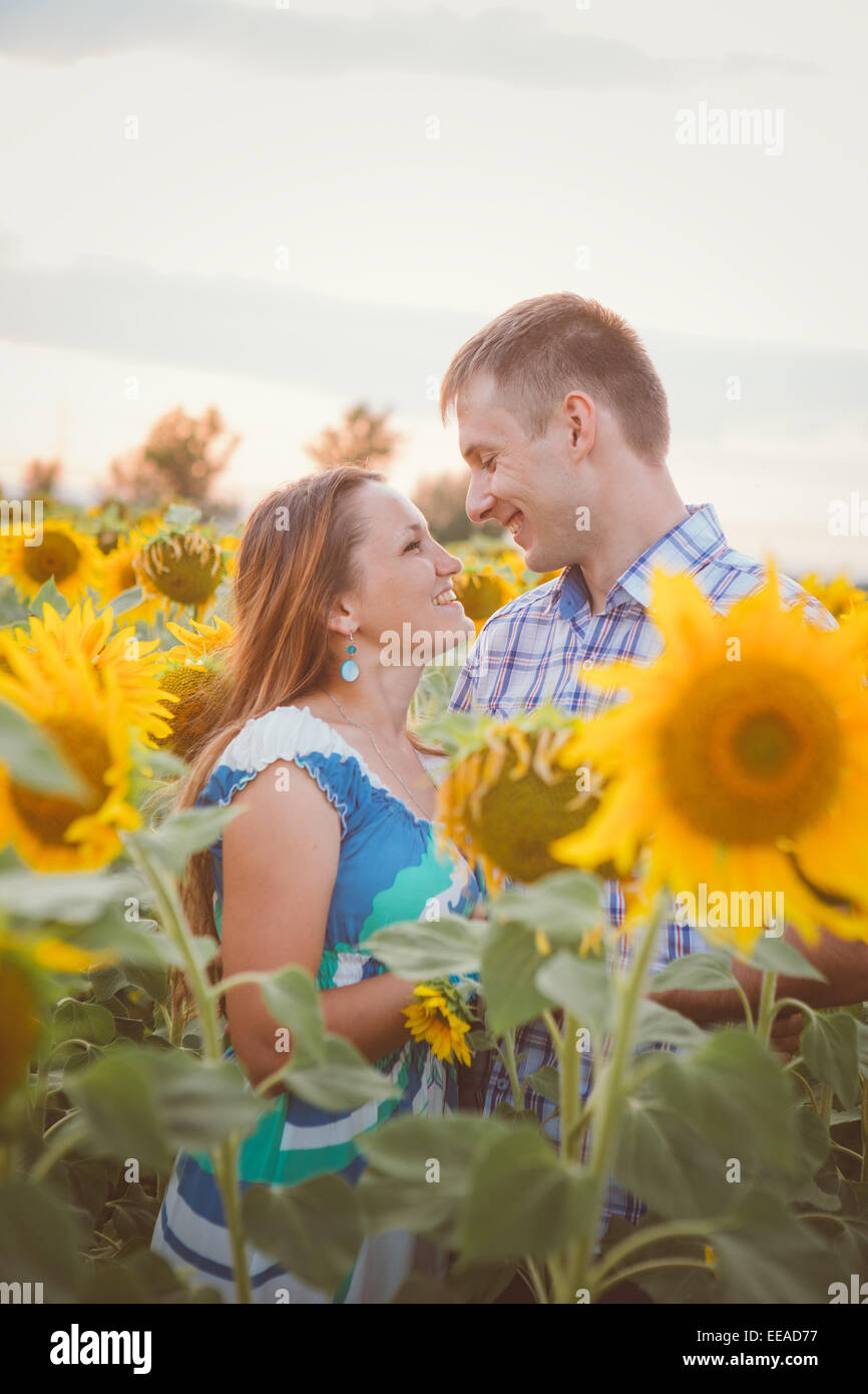 Beautiful couple having fun in sunflowers fields Stock Photo - Alamy