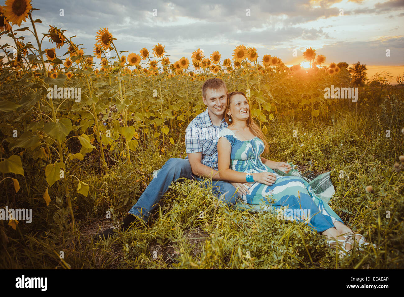 Beautiful couple having fun in sunflowers fields Stock Photo - Alamy