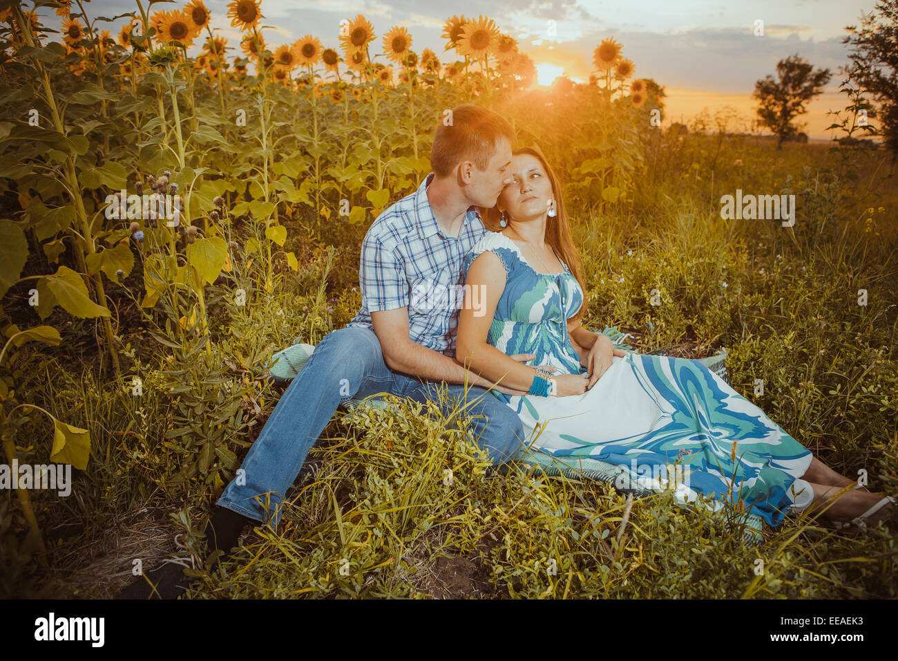 Beautiful couple having fun in sunflowers fields Stock Photo - Alamy