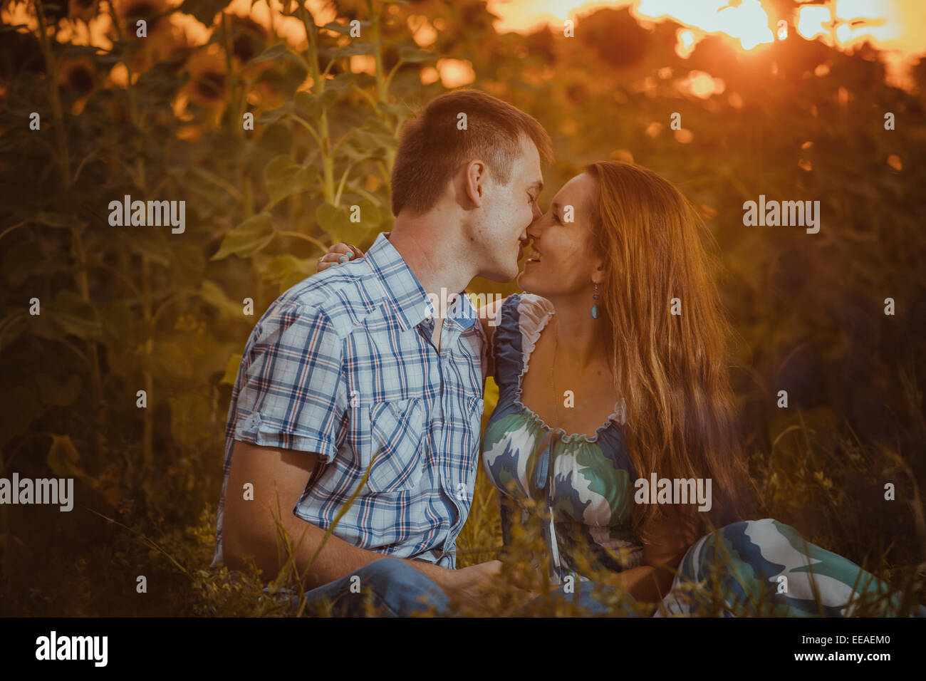 Beautiful couple having fun in sunflowers fields Stock Photo - Alamy