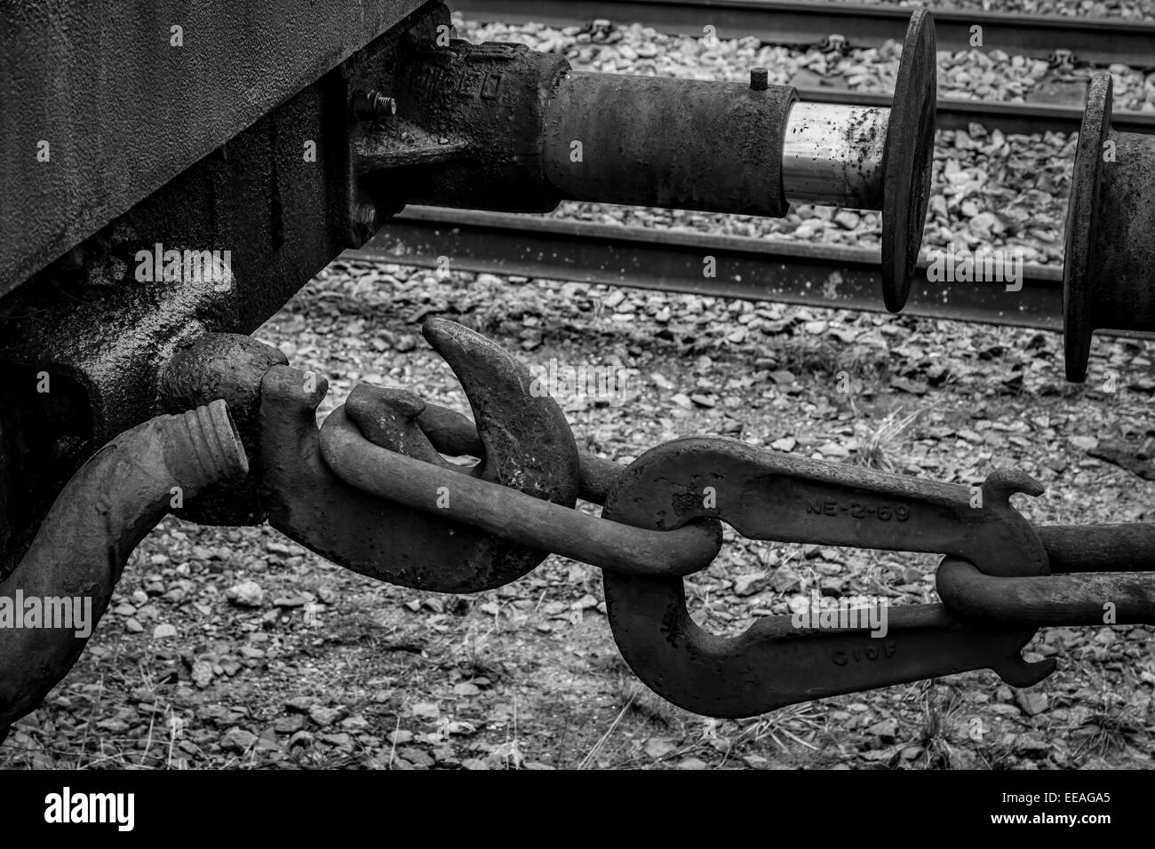 Close up and isolated black and white, mono photograph of the coupling and buffer on a railway carriage. Stock Photo