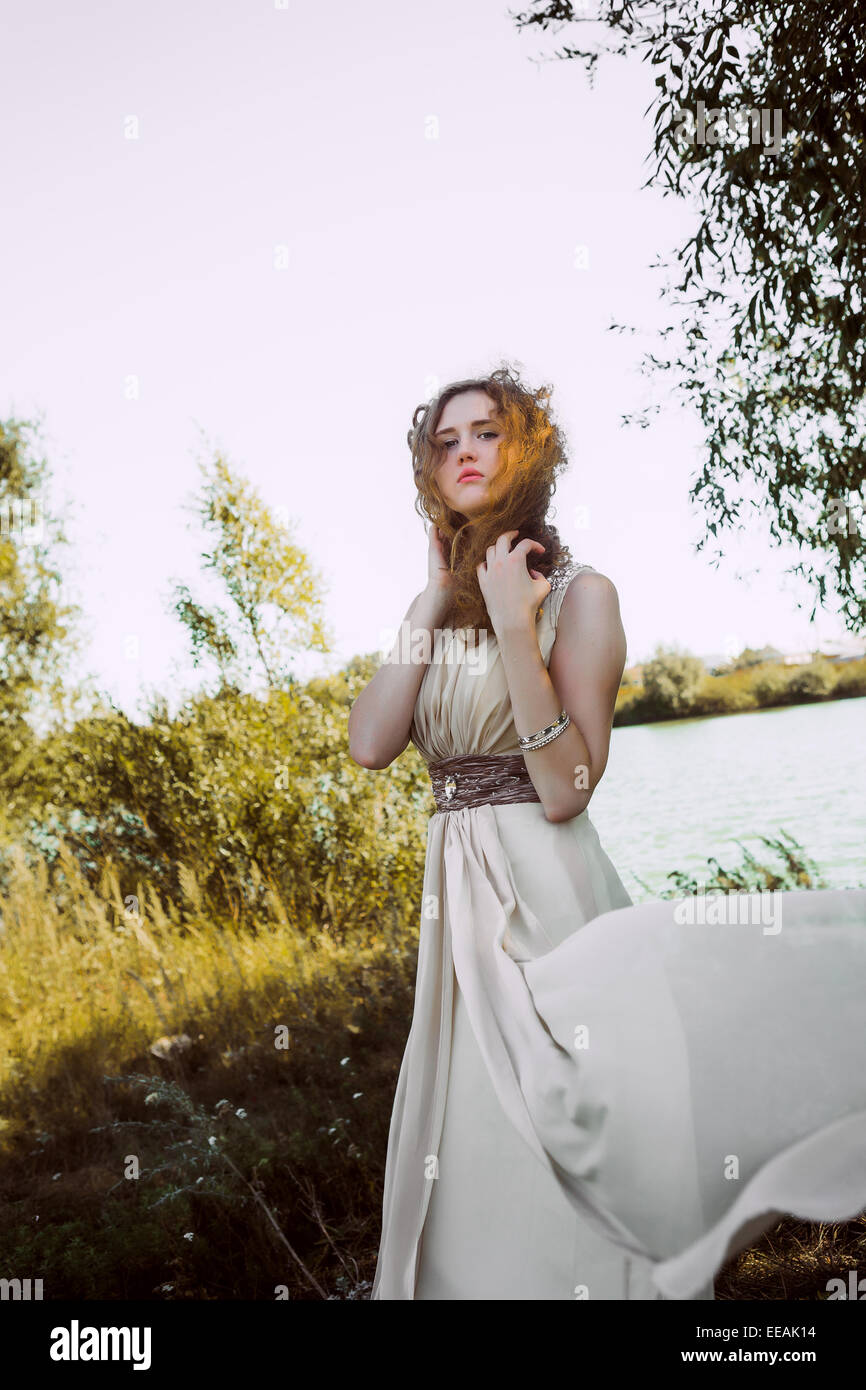beautiful girl in white dress on a lake shore Stock Photo - Alamy