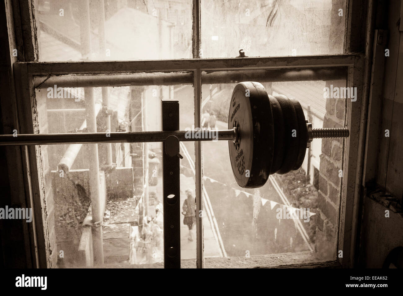 Weights near old sash window Stock Photo