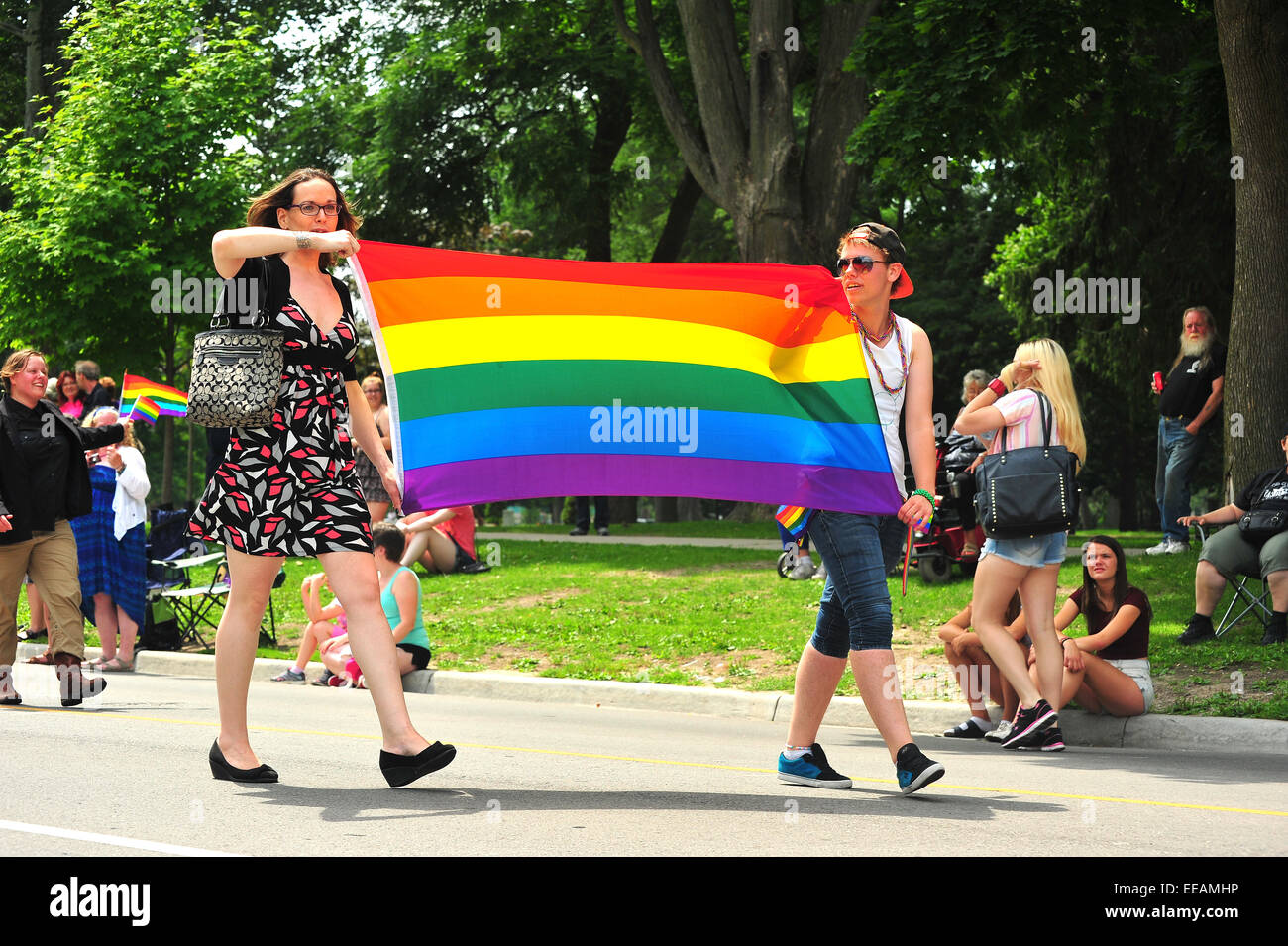 Women carrying the rainbow pride flag during a pride parade in London, Ontario Stock Photo Alamy
