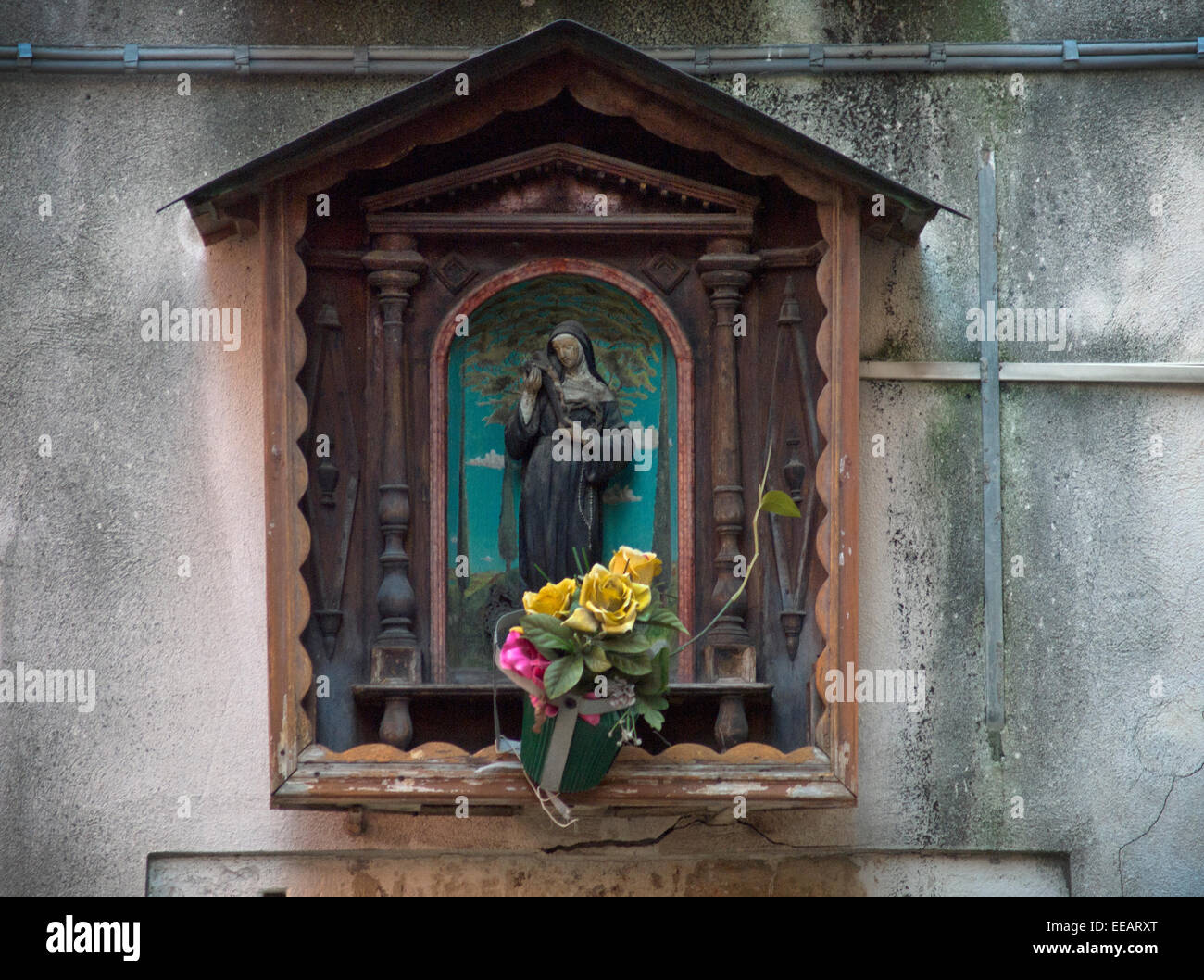 A small shrine, attached to a wall in a backstreet of Venice, Italy ...