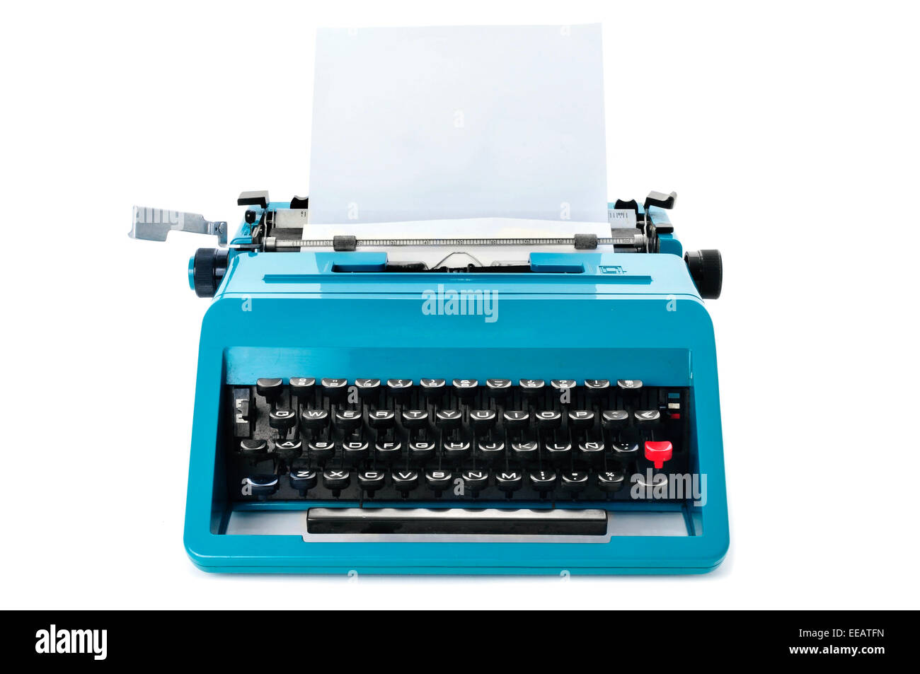 a retro blue typewriter with a blank paper on a white background Stock Photo