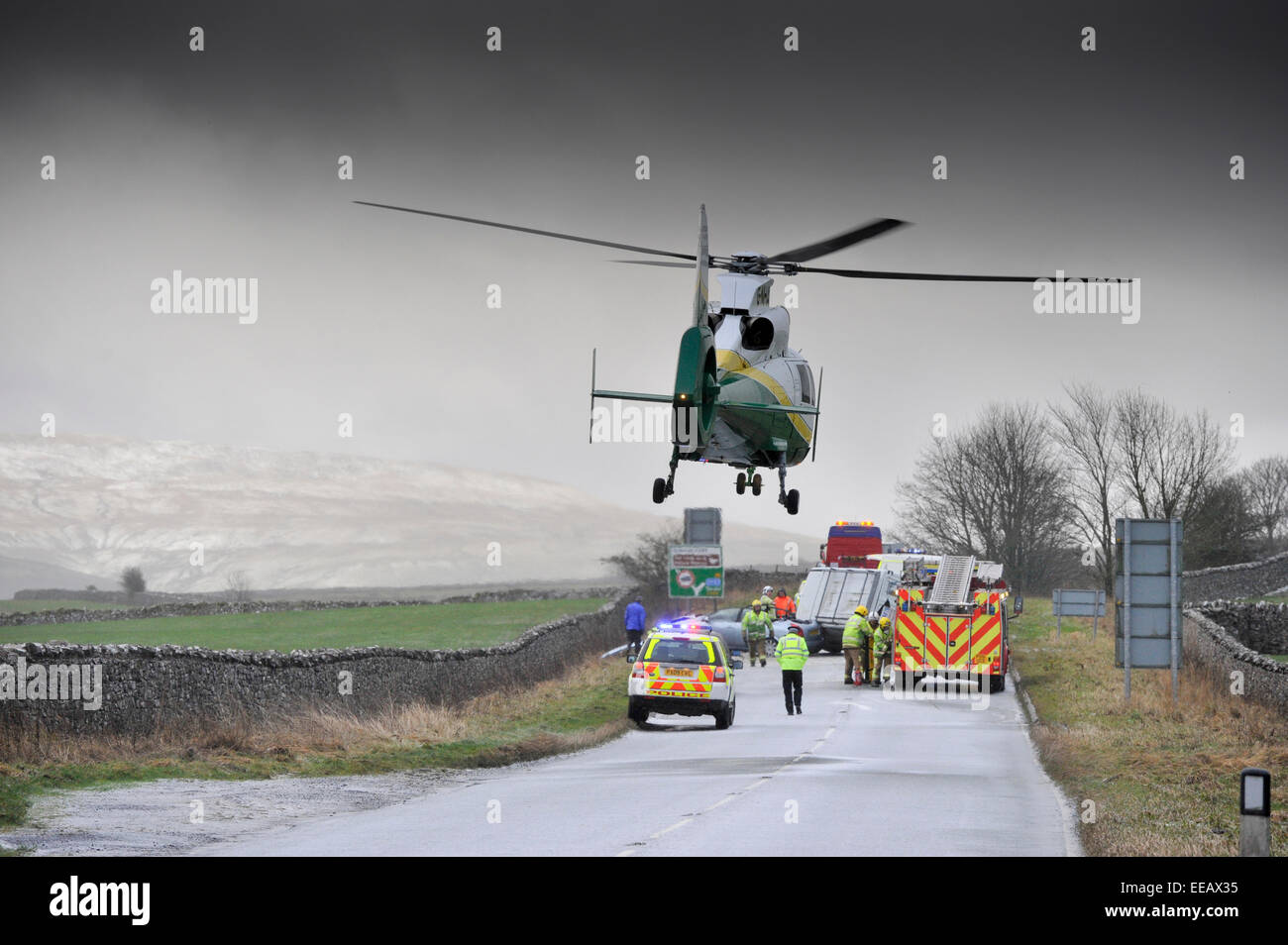 Air Ambulance attending a road traffic accidentin icy weather, Kirkby Stephen, Cumbria, UK Stock Photo