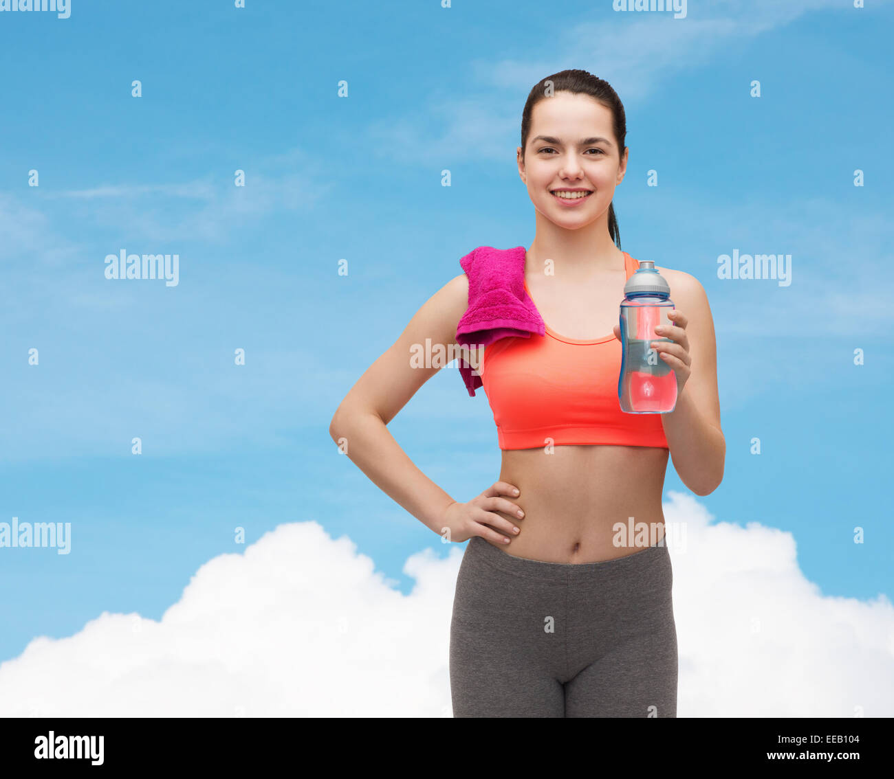 sporty woman with towel and water bottle Stock Photo - Alamy