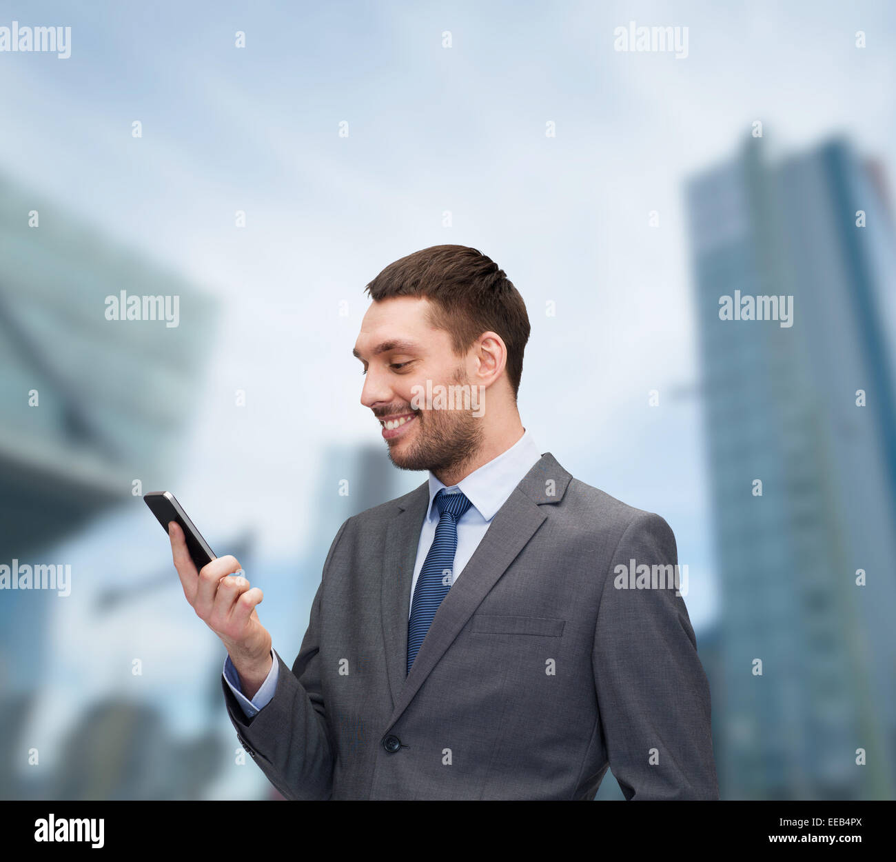 young smiling businessman with smartphone Stock Photo - Alamy