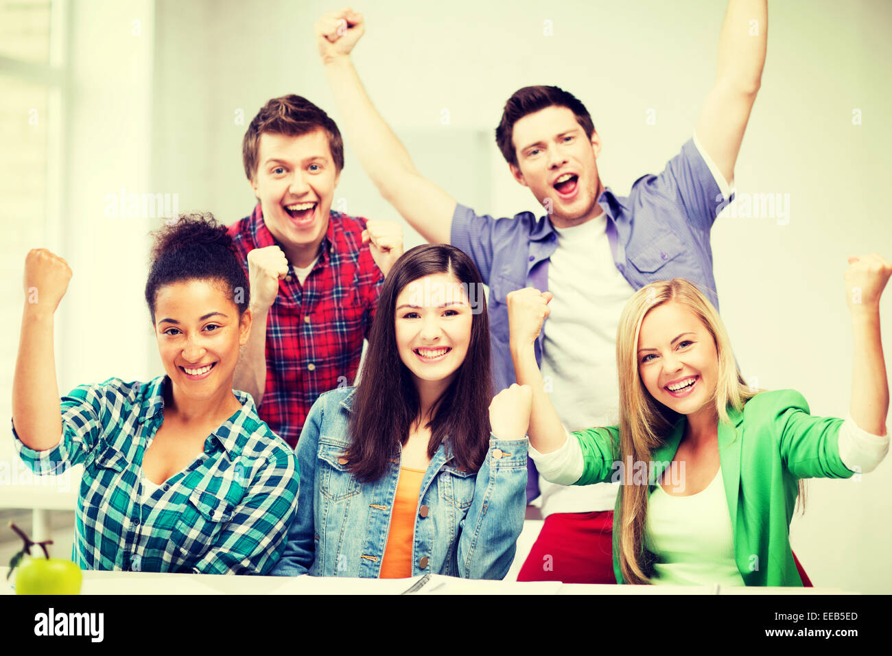 students holding hands up at school Stock Photo - Alamy