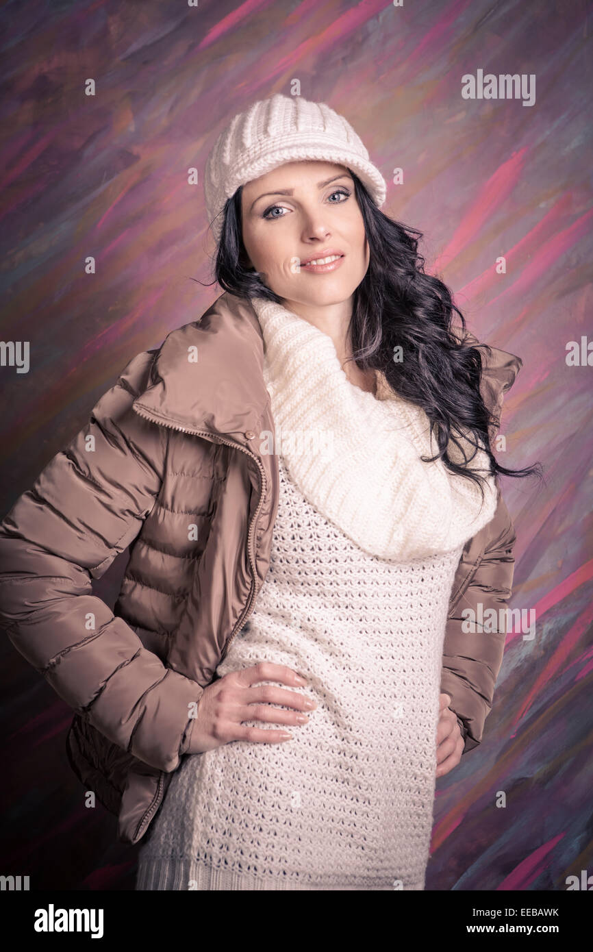 studio portrait of a young woman with winter clothes Stock Photo