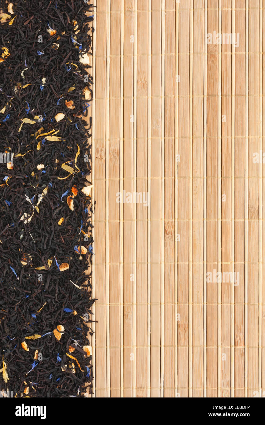Dried  black  tea  on a bamboo mat, with space for text, for menu Stock Photo