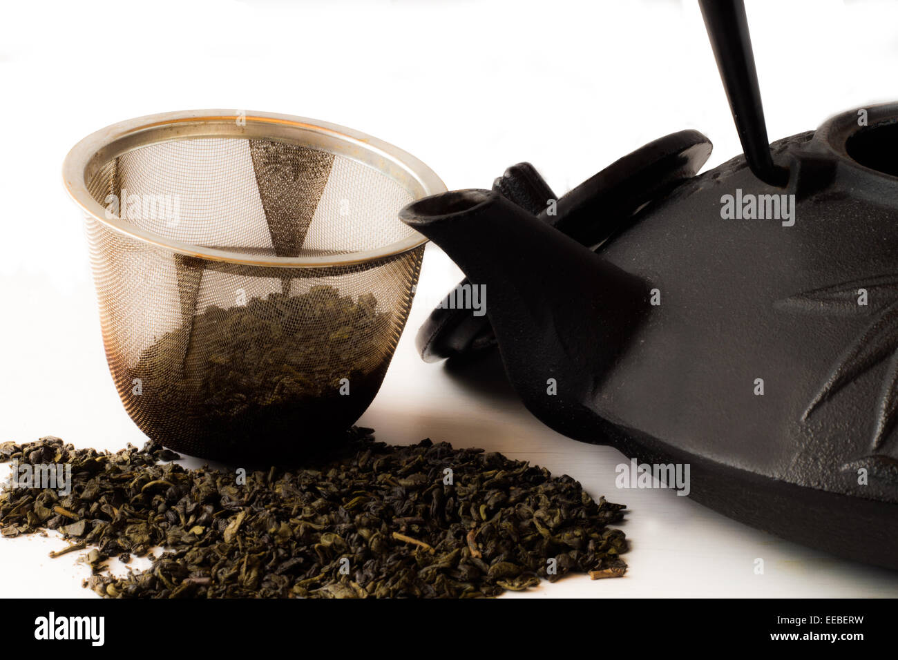 Teapot with strainer open and tea leaves Stock Photo Alamy