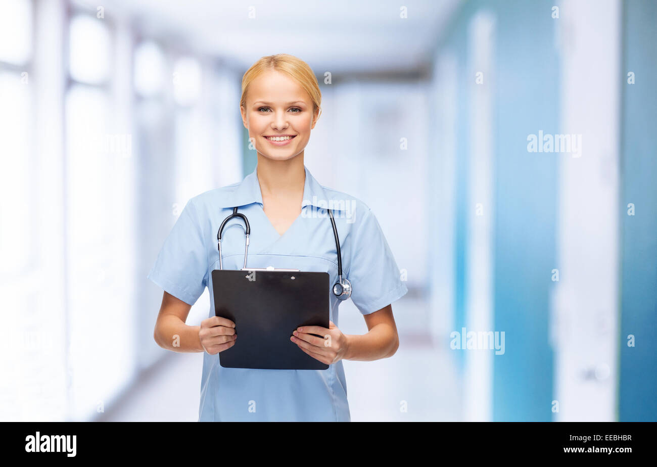 smiling female doctor or nurse with clipboard Stock Photo - Alamy