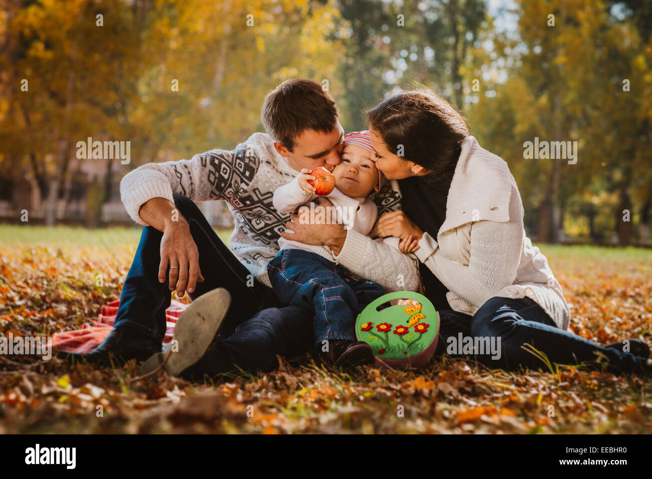 Happy mother, father and daughter in the park Stock Photo - Alamy