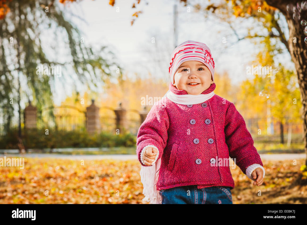 adorable little girl with autumn leaves in the beauty park Stock Photo ...